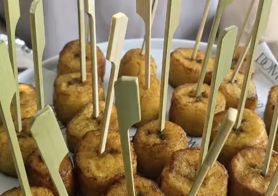 Plantain skewers served from a branded Domu station